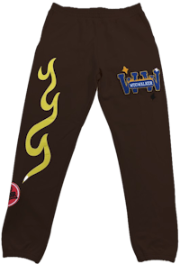 a brown sweatpants with yellow flames on them